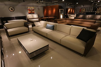Elegant living room showcasing modern furniture with plush sofas and ambient lighting. HD wallpaper