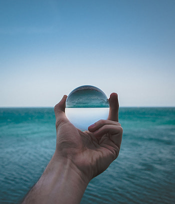 Sea, Reflection, Hand, Miscellanea, Miscellaneous, Glass, Ball, Distortion HD phone wallpaper