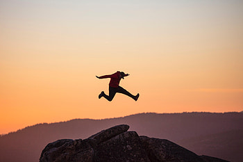 Sunset, Rocks, Miscellanea, Miscellaneous, Cap, Bounce, Jump HD wallpaper