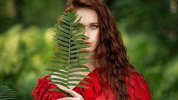 Beautiful Light Green Eyes Girl Model With Leaves Is Wearing Red Dress Standing In Blur Green Background Girls HD wallpaper