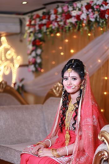 South Asian bride in traditional wedding attire with floral and gold accents indoors. HD phone wallpaper