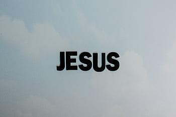Minimalist with bold 'JESUS' text against a cloudy sky background. HD wallpaper