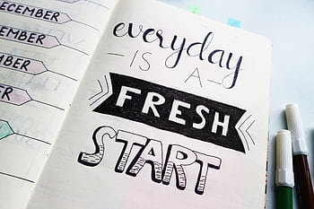 Notebook page featuring motivational quote 'Everyday is a fresh start' with colorful pens. HD wallpaper