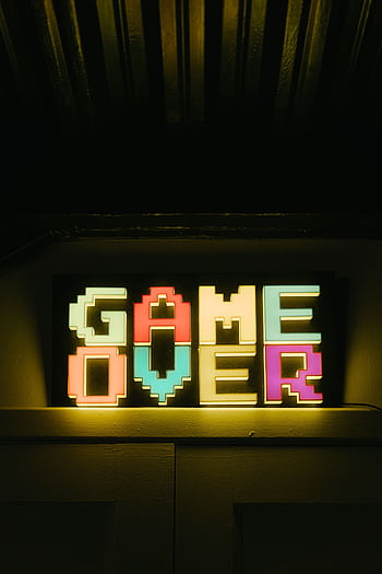 Bright neon 'Game Over' sign in retro style, perfect for gaming nostalgia HD phone wallpaper