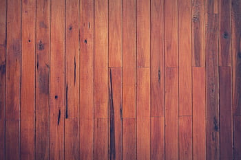 Close-up view of a rustic wooden plank floor with rich brown tones and visible wood grain. HD wallpaper