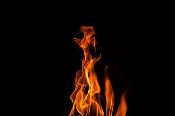 A dynamic and captivating of flames on a dark backdrop, showcasing vivid colors and intense energy. HD wallpaper
