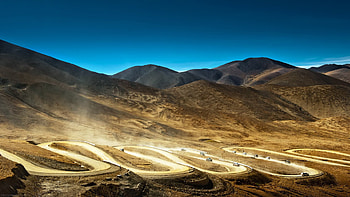 serpentine road in tibet mountains, dust, desert, road, vehicles, mountains HD wallpaper