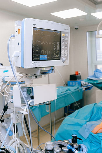 Close-up of vital signs monitor in a modern operating room setup. HD phone wallpaper