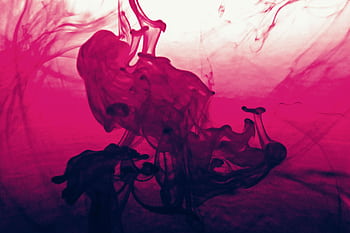 Vibrant abstract artwork featuring swirling pink and red liquid ink patterns. HD wallpaper
