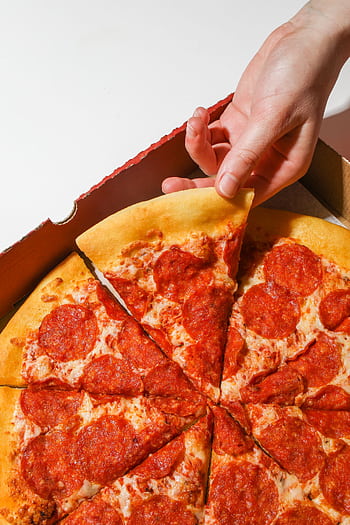Close-up of a hand picking a pepperoni pizza slice from a box. HD phone wallpaper