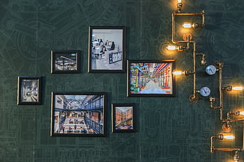 Industrial style wall art with vintage pipe lighting on a green textured wall adds a unique touch. HD wallpaper