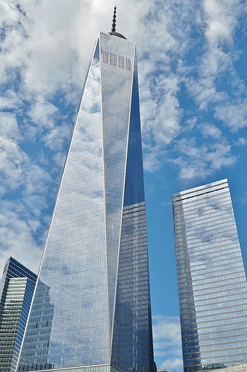 A striking view of One World Trade Center reflecting clouds in New York City. HD phone wallpaper