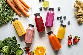 Colorful assortment of organic juices with fresh ingredients for a healthy lifestyle. HD wallpaper