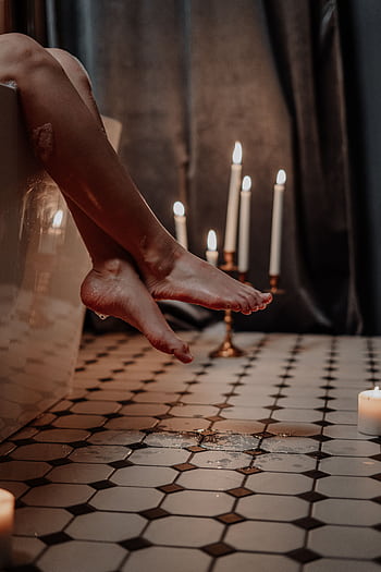 Relaxing bathtub scene with candles and ambient lighting creates a serene mood. HD phone wallpaper