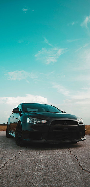 Mitsubishi Lancer , Black matte Lancer, Skyline backdrop, Sports car aesthetics HD phone wallpaper