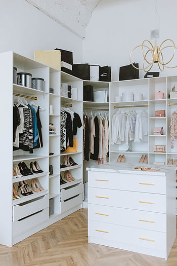 A stylish walk-in closet featuring luxury clothing, shoes, and accessories, with elegant shelving and chandeliers. HD phone wallpaper