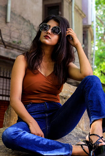 Fashionable woman in trendy sunglasses and denim, posing confidently outdoors. HD phone wallpaper