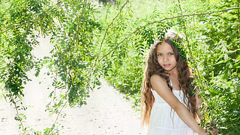 Beautiful Cute Little Girl Is Standing In Green Leaves Tree Branches Bushes Background Wearing White Dress Cute HD wallpaper