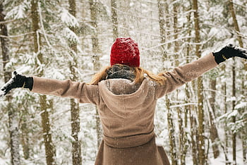 Woman in red hat enjoying a snowy winter day in Lake Placid forest. HD wallpaper