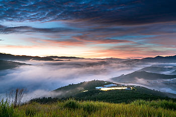 Stunning sunrise over foggy valley with vibrant sky and misty mountains, perfect for travel and nature inspiration. HD wallpaper