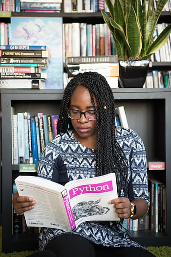 African American woman studying Python programming in a library setting. HD phone wallpaper