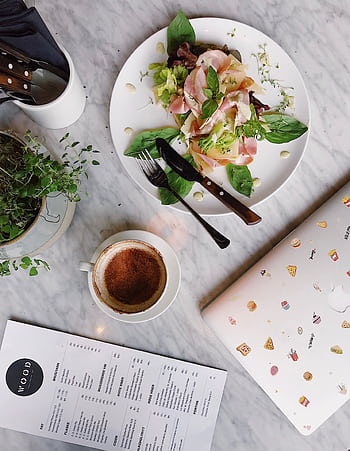 Top view of an elegant breakfast setup featuring coffee, fresh salad, and a laptop over a marble table. HD phone wallpaper