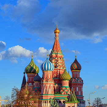Colorful domes of St. Basil's Cathedral against a vibrant blue sky in Moscow, Russia. HD phone wallpaper