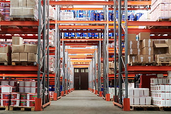 Wide angle view of a warehouse with stocked shelves and boxes. HD wallpaper