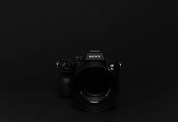 Minimalist of a black Sony camera against a black background, perfect for tech themes. HD wallpaper