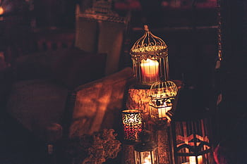 A cozy indoor scene with glowing lanterns and candles, perfect for creating ambiance. HD wallpaper