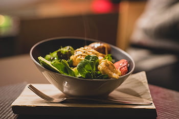 Delicious bowl of salad with fresh greens and grilled chicken served on a wooden platter. HD wallpaper