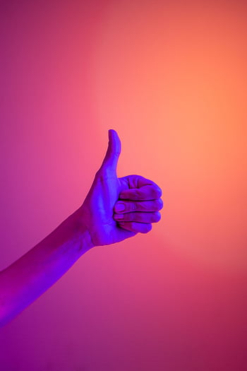 A neon-illuminated hand giving a thumbs up against a vibrant gradient background, symbolizing approval and positivity. HD phone wallpaper