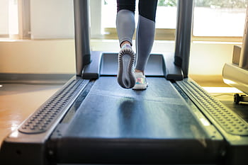 Close-up shot of a person exercising on a treadmill, showcasing fitness and health focus. HD wallpaper