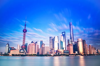 Vibrant Shanghai skyline featuring the iconic Oriental Pearl Tower and modern skyscrapers. HD wallpaper