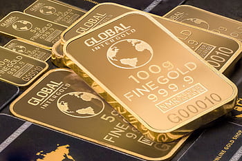 A detailed shot of gold bars labeled 'Global Intergold' as a symbol of wealth and investment. HD wallpaper