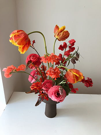 Colorful flower bouquet featuring tulips, roses, and greenery in a vase. HD phone wallpaper