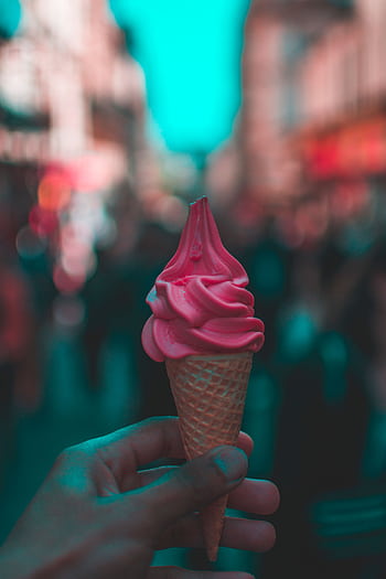 A hand-held pink ice cream cone on a bustling Paris street. HD phone wallpaper