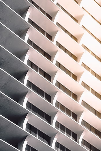 A captivating perspective of a modern, futuristic building in Miami showcasing sleek design and geometry. HD phone wallpaper