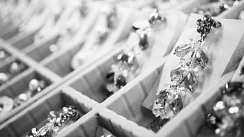Close-up of elegant crystal earrings in a display box highlighting intricate jewelry details. HD wallpaper