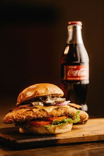 Mouth-watering burger with a bottle of cola, perfect for fast food lovers. HD phone wallpaper