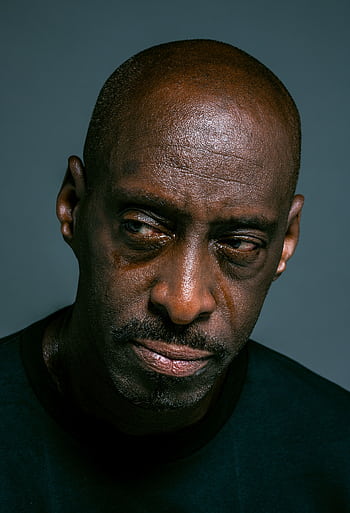 Close-up portrait of a man with a serious, reflective expression, conveying deep emotion. HD phone wallpaper