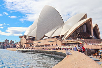 Sydney Opera House with tourists and waterfront view on a sunny day. HD wallpaper