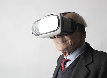 Senior man with VR headset, embracing futuristic technology indoors. HD wallpaper