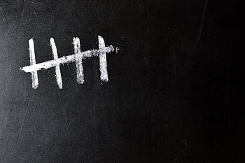 Five chalk tally marks on a black chalkboard background. HD wallpaper