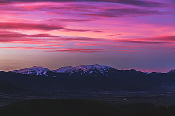 Gorgeous twilight sky with pink hues over a peaceful snow-capped mountain range. HD wallpaper