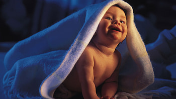 Smiling Cute Baby Is Sitting Under White Towel In Dark Background Cute HD wallpaper