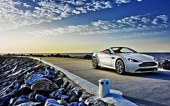 astin martin on a stone pier, convertible, car, clouds, pier, rocks HD wallpaper