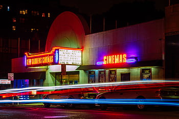 Vibrant night view of New Gardens Cinemas in Queens, New York with colorful neon lights and light streaks. HD wallpaper
