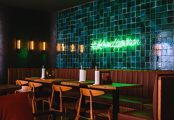 Contemporary restaurant interior with green tile wall and neon sign in Sochi, Russia. HD wallpaper