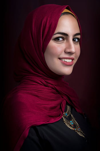 Stunning profile portrait of a woman wearing a red hijab, showcasing beauty and elegance. HD phone wallpaper